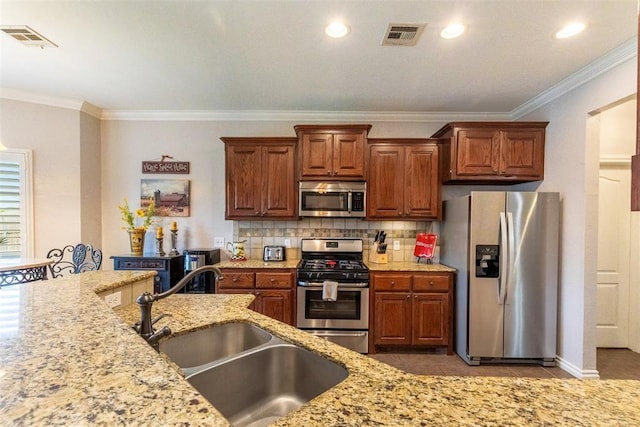 1106 Prairie Dunes Ct, Norman, OK 73072 - kitchen featuring stainless steel appliances, ornamental molding, light stone countertops, decorative backsplash, and brown cabinets