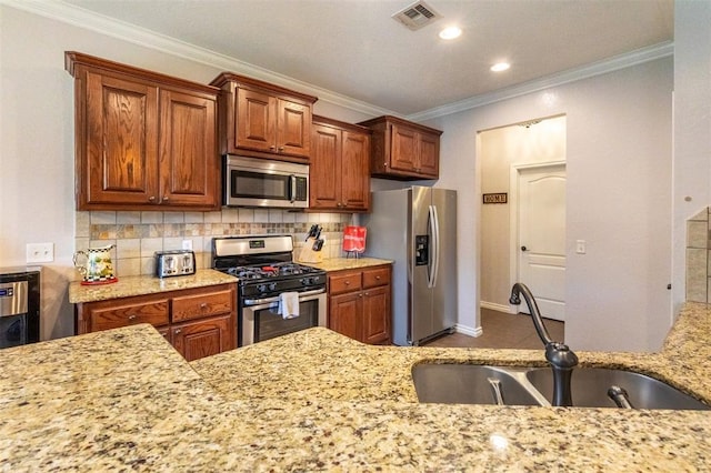 1106 Prairie Dunes Ct, Norman, OK 73072 - kitchen with stainless steel appliances, ornamental molding, decorative backsplash, recessed lighting, and brown cabinets
