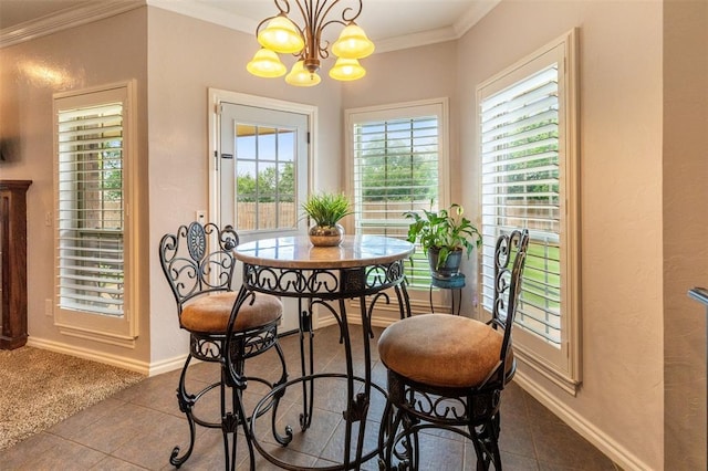 1106 Prairie Dunes Ct, Norman, OK 73072 - dining space with crown molding, a chandelier, and dark tile patterned floors