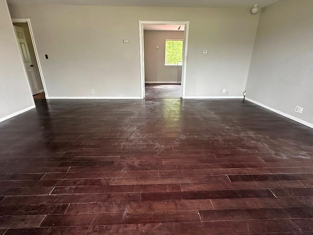 115 S Main St, Sharon, OK 73857 - empty room featuring dark wood-type flooring and baseboards