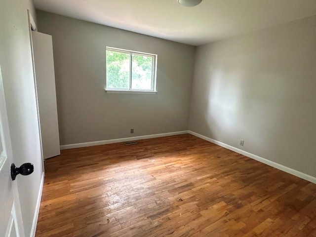 115 S Main St, Sharon, OK 73857 - empty room with wood finished floors