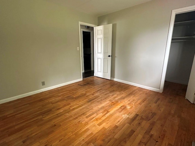 115 S Main St, Sharon, OK 73857 - unfurnished bedroom with wood finished floors, a closet, and a spacious closet