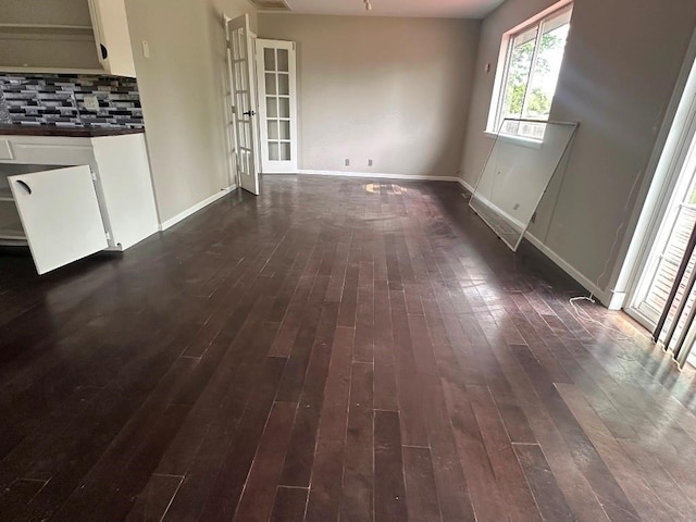115 S Main St, Sharon, OK 73857 - unfurnished dining area featuring dark wood-style flooring and baseboards