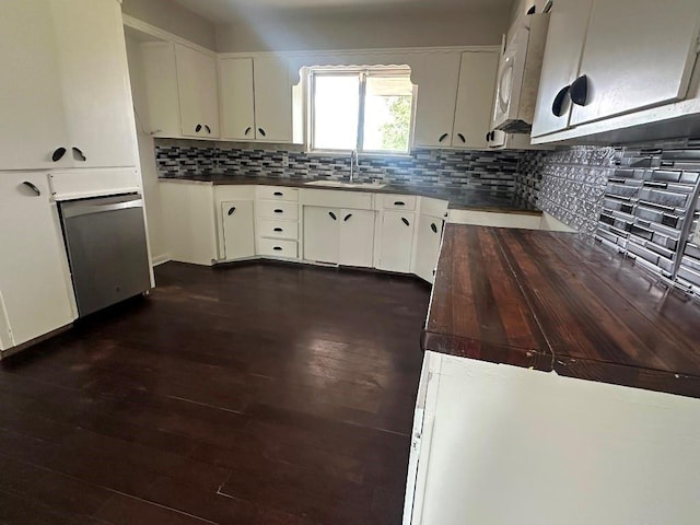115 S Main St, Sharon, OK 73857 - kitchen with dark wood-style flooring, backsplash, white cabinetry, and dishwasher