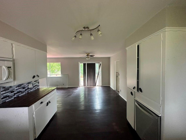 115 S Main St, Sharon, OK 73857 - kitchen with white microwave, backsplash, a ceiling fan, wood counters, and white cabinets