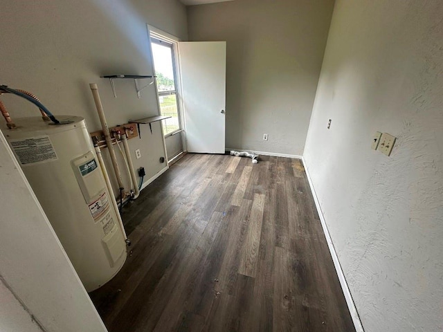 115 S Main St, Sharon, OK 73857 - interior space with electric water heater, dark wood-type flooring, electric dryer hookup, and washer hookup
