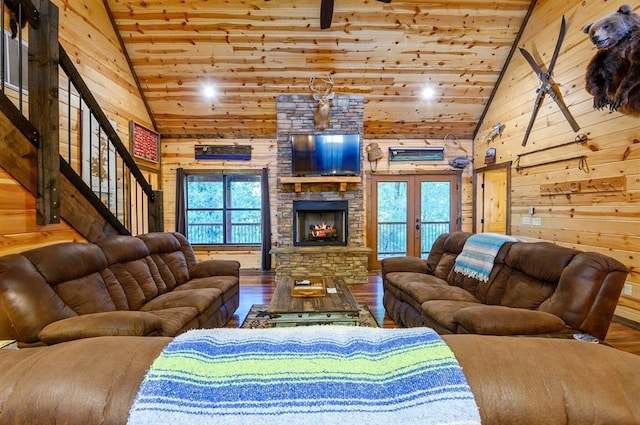 708 Split Creek Ln, Broken Bow, OK 74728 - living area with high vaulted ceiling, wood walls, wood ceiling, hardwood / wood-style flooring, and stairway