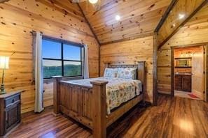 708 Split Creek Ln, Broken Bow, OK 74728 - bedroom featuring dark wood finished floors, wood walls, wooden ceiling, and high vaulted ceiling