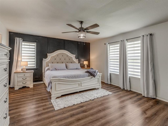 111 E Memorial, Marlow, OK 73055 - bedroom with wood finished floors, multiple windows, and ceiling fan