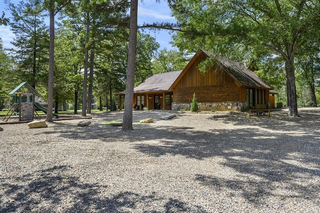 99 Sawtooth Pine Rd, Broken Bow, OK 74728 - view of side of home featuring a playground and stone siding