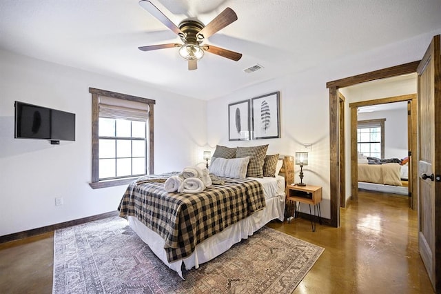 99 Sawtooth Pine Rd, Broken Bow, OK 74728 - bedroom with concrete floors and a ceiling fan