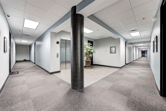 444 N Central Ave Unit 106, Oklahoma City, OK 73104 - hallway featuring a drop ceiling, elevator, and light colored carpet