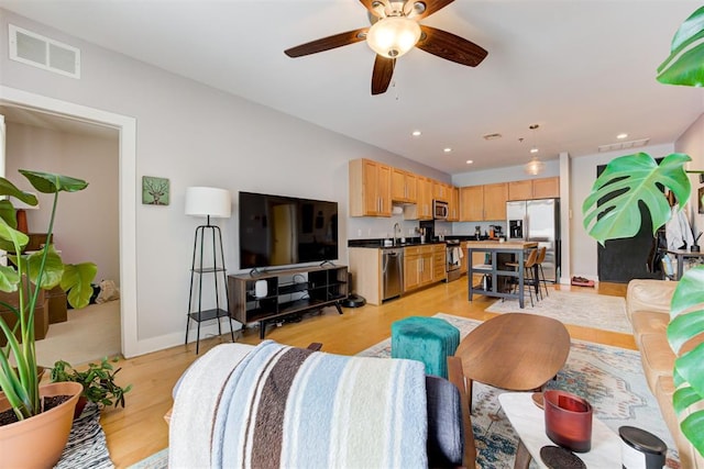 444 N Central Ave Unit 106, Oklahoma City, OK 73104 - living area with light wood-style floors, a ceiling fan, and recessed lighting