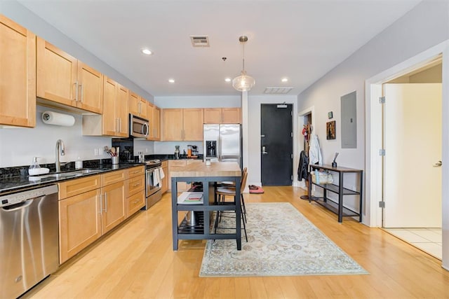 444 N Central Ave Unit 106, Oklahoma City, OK 73104 - kitchen with stainless steel appliances, light brown cabinetry, light wood finished floors, electric panel, and recessed lighting