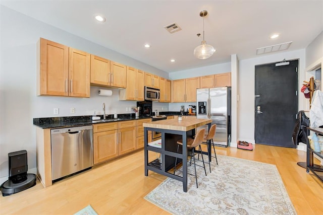 444 N Central Ave Unit 106, Oklahoma City, OK 73104 - kitchen with appliances with stainless steel finishes, light brown cabinets, light wood-style flooring, and recessed lighting