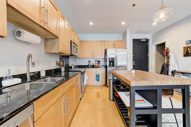 444 N Central Ave Unit 106, Oklahoma City, OK 73104 - kitchen with appliances with stainless steel finishes, light wood-style flooring, light brown cabinetry, recessed lighting, and dark stone counters