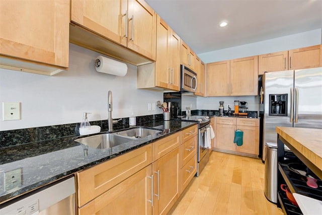 444 N Central Ave Unit 106, Oklahoma City, OK 73104 - kitchen featuring stainless steel appliances, light brown cabinetry, light wood-type flooring, dark stone counters, and recessed lighting