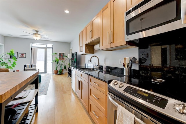 444 N Central Ave Unit 106, Oklahoma City, OK 73104 - kitchen with appliances with stainless steel finishes, a ceiling fan, light brown cabinets, light wood-style flooring, and dark stone counters