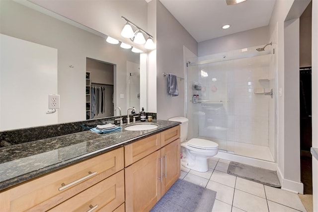 444 N Central Ave Unit 106, Oklahoma City, OK 73104 - bathroom featuring a spacious closet, tile patterned floors, a shower stall, and vanity