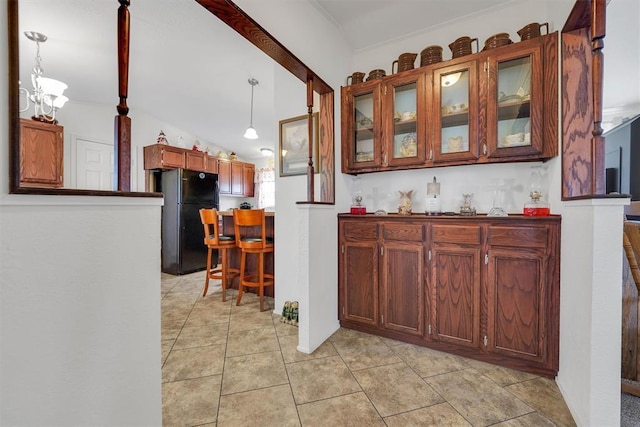 11221 N 1928th Rd, Sayre, OK 73662 - bar with freestanding refrigerator, a chandelier, pendant lighting, lofted ceiling, and light tile patterned floors