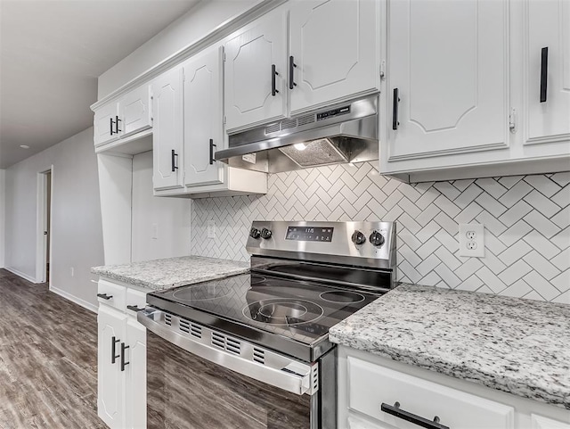 209 SW 6th St, Blanchard, OK 73010 - kitchen with stainless steel range with electric cooktop, under cabinet range hood, decorative backsplash, white cabinetry, and wood finished floors