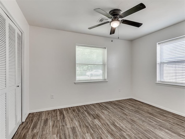 209 SW 6th St, Blanchard, OK 73010 - unfurnished bedroom with wood finished floors, multiple windows, and a closet