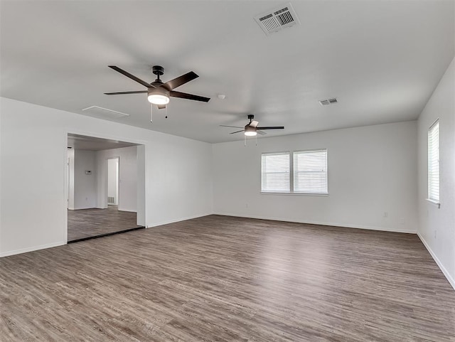 209 SW 6th St, Blanchard, OK 73010 - empty room with plenty of natural light, wood finished floors, and ceiling fan