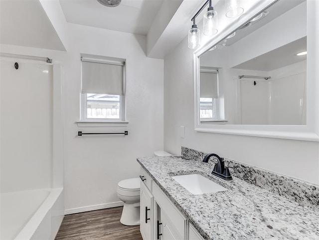 209 SW 6th St, Blanchard, OK 73010 - full bath with vanity, healthy amount of natural light, wood finished floors, and bathtub / shower combination