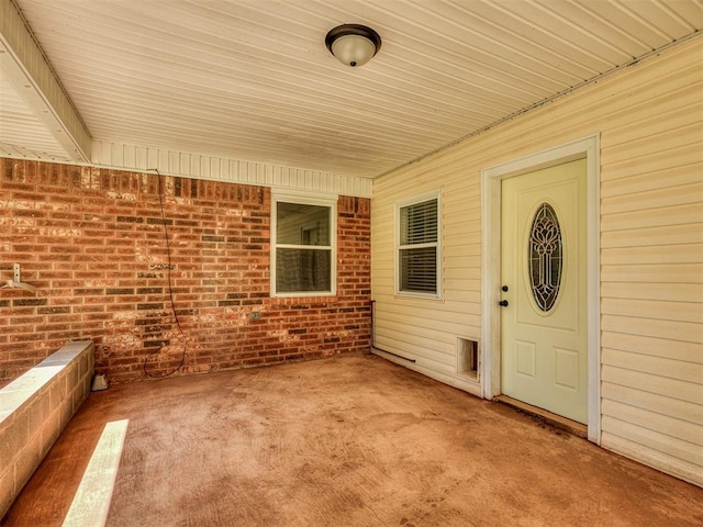 209 SW 6th St, Blanchard, OK 73010 - doorway to property featuring brick siding and a patio