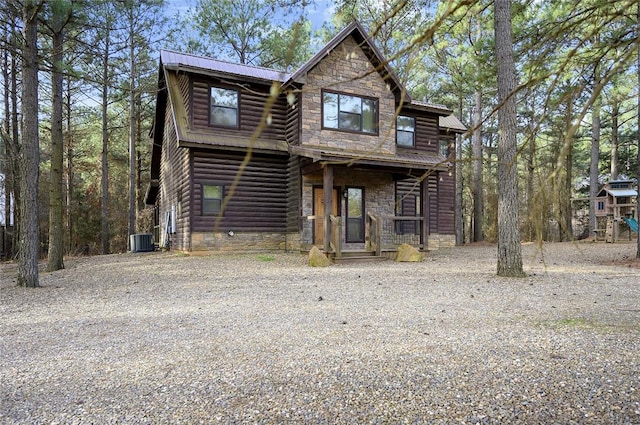 318 Camp Ranch Rd, Broken Bow, OK 74728 - view of front of house featuring stone siding, a metal roof, and faux log siding