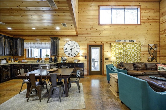 318 Camp Ranch Rd, Broken Bow, OK 74728 - dining space featuring wooden walls, finished concrete floors, and recessed lighting