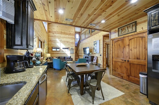 318 Camp Ranch Rd, Broken Bow, OK 74728 - dining room featuring finished concrete floors, wooden walls, recessed lighting, and wooden ceiling