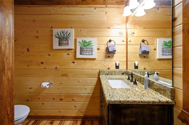318 Camp Ranch Rd, Broken Bow, OK 74728 - bathroom with vanity, wooden walls, and wood finished floors