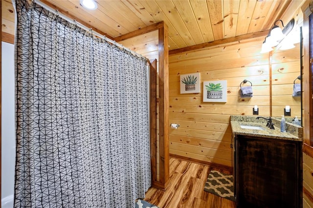 318 Camp Ranch Rd, Broken Bow, OK 74728 - bathroom with wooden ceiling, wood finished floors, wooden walls, vanity, and a shower with shower curtain