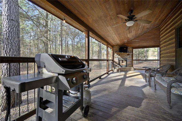 318 Camp Ranch Rd, Broken Bow, OK 74728 - wooden deck featuring an outdoor stone fireplace, a ceiling fan, and grilling area