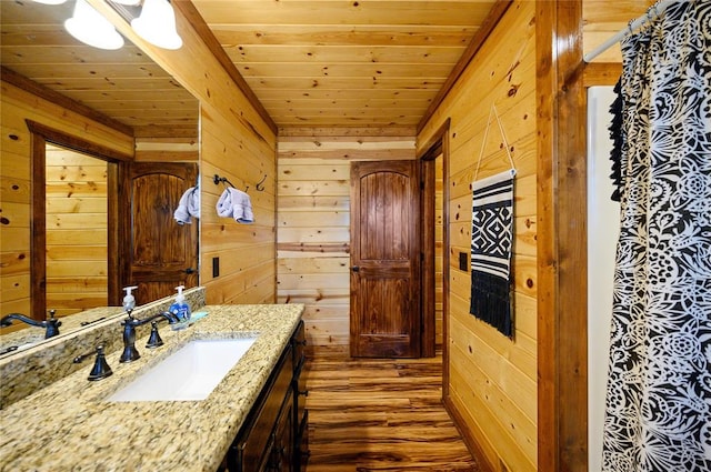 318 Camp Ranch Rd, Broken Bow, OK 74728 - bathroom featuring wooden ceiling, wooden walls, wood finished floors, and vanity