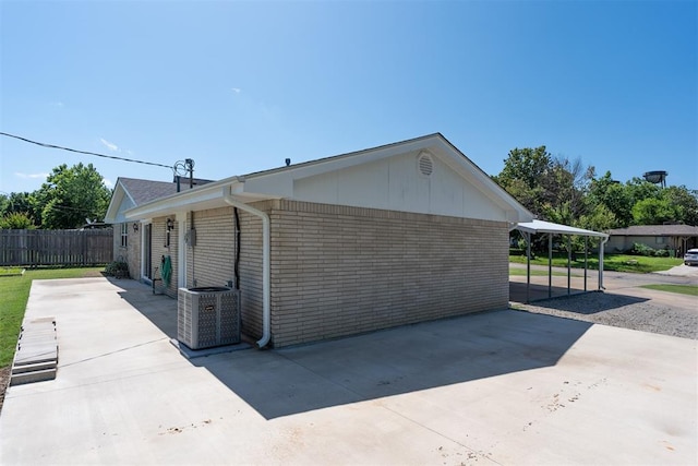 822 W Broadway St, Okemah, OK 74859 - view of home's exterior featuring brick siding and a patio area