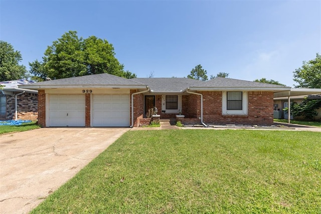 929 NE 5th St, Moore, OK 73160 - ranch-style home featuring an attached garage, concrete driveway, brick siding, and a front lawn