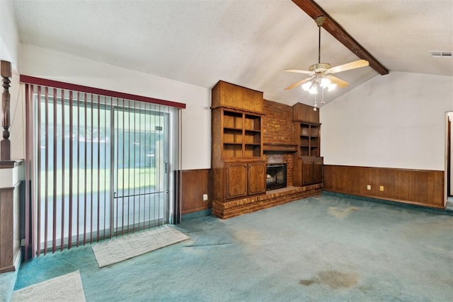 929 NE 5th St, Moore, OK 73160 - unfurnished living room with a wainscoted wall, a fireplace, wood walls, ceiling fan, and carpet