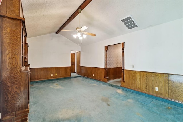929 NE 5th St, Moore, OK 73160 - spare room with a wainscoted wall, wood walls, a ceiling fan, carpet, and a textured ceiling