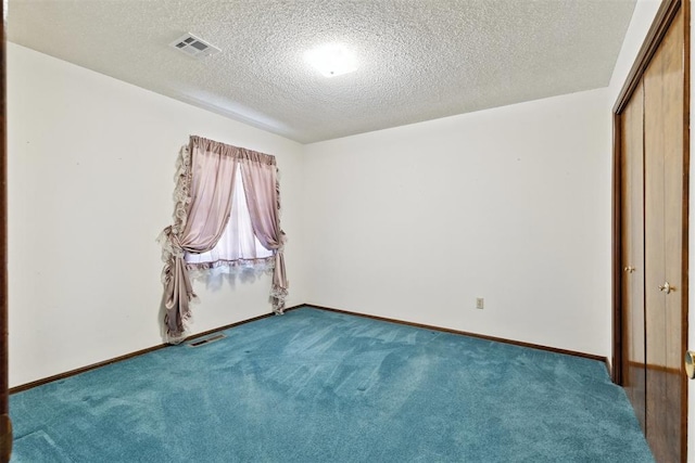 929 NE 5th St, Moore, OK 73160 - unfurnished bedroom featuring carpet flooring, a textured ceiling, and a closet