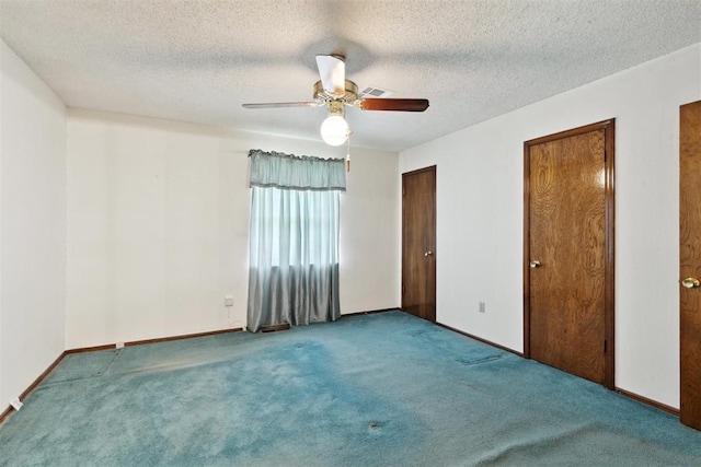 929 NE 5th St, Moore, OK 73160 - unfurnished bedroom featuring carpet flooring, multiple closets, ceiling fan, and a textured ceiling