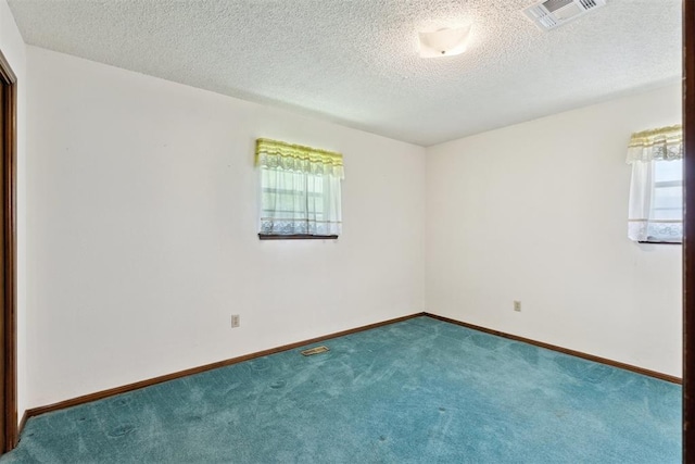 929 NE 5th St, Moore, OK 73160 - carpeted empty room with plenty of natural light and a textured ceiling