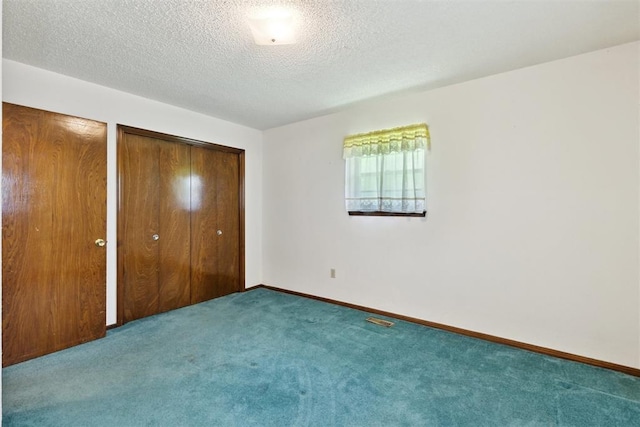 929 NE 5th St, Moore, OK 73160 - unfurnished bedroom with carpet floors and a textured ceiling