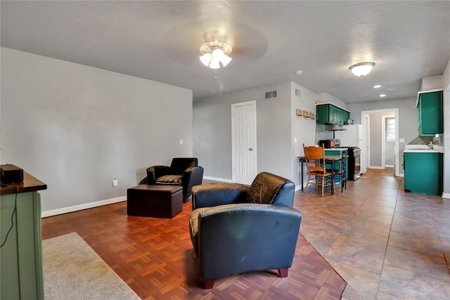 1001 NW 2nd St, Moore, OK 73160 - living room featuring a ceiling fan and baseboards
