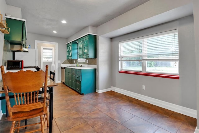 1001 NW 2nd St, Moore, OK 73160 - kitchen featuring green cabinetry, light countertops, recessed lighting, freestanding refrigerator, and black microwave