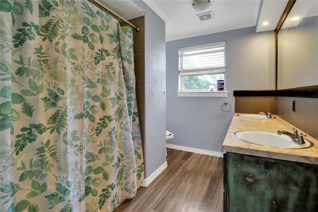 1001 NW 2nd St, Moore, OK 73160 - full bath with wood finished floors, double vanity, and a shower with curtain