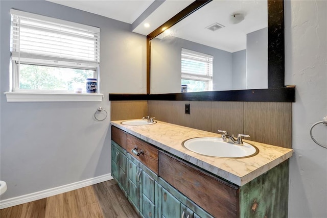 1001 NW 2nd St, Moore, OK 73160 - full bathroom featuring double vanity and wood finished floors