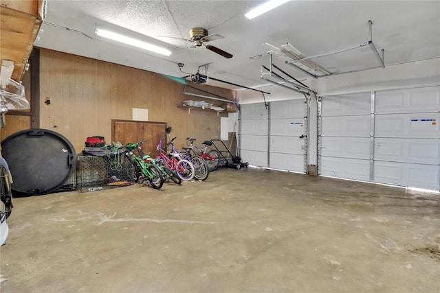 1001 NW 2nd St, Moore, OK 73160 - garage featuring heating fuel, wooden walls, and a garage door opener
