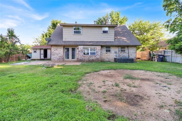 1001 NW 2nd St, Moore, OK 73160 - back of property with a patio, brick siding, a fenced backyard, and roof with shingles